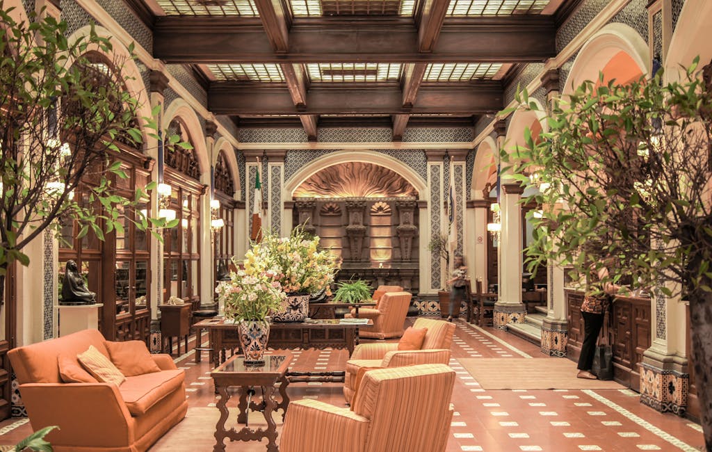 A modern luxury hotel lobby with lush indoor greenery and natural light reflecting the convergence of wellness tourism and luxury hospitality