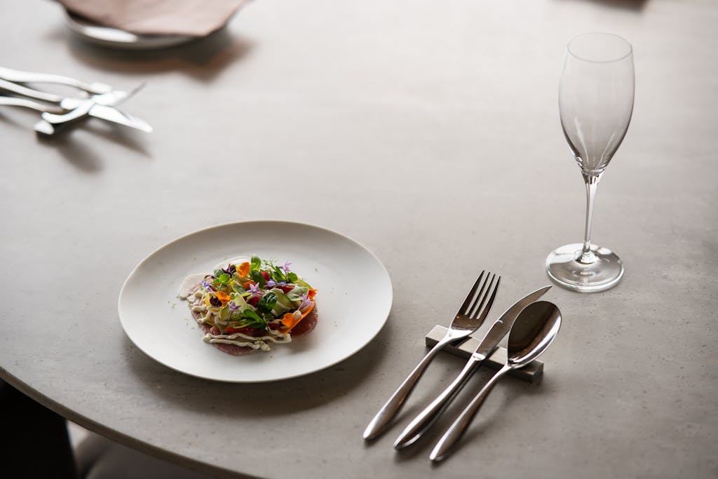 An intimate fine dining table set with a multi-course vegetarian tasting menu and wine pairing at a Michelin-starred plant-based restaurant