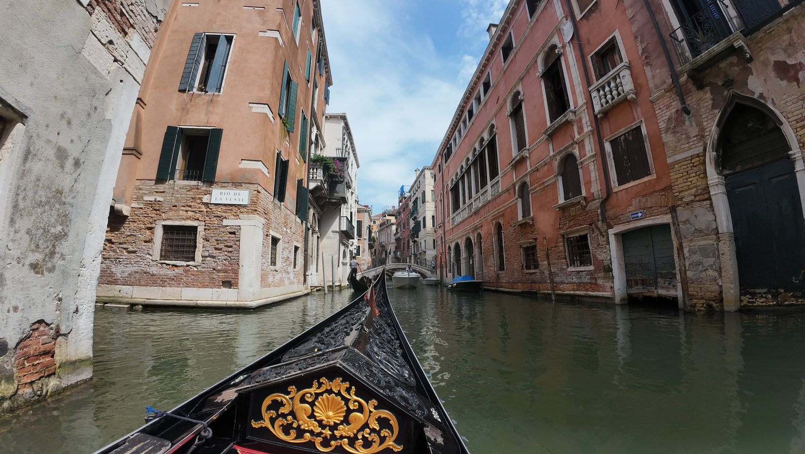 Venice 3 day itinerary - narrow canal seen from the bow of a gondola